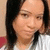 A person with long dark hair wearing a white striped shirt appears in a four- with subtle facial expression changes