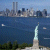 Static pixelated image of a city skyline with water and a tall monument, likely New York City, rendered in low-resolution 256x256 pixels.