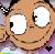 Pixelated cartoon face with large white eyes, brown skin, and a wide smile, set against a blurred background with purple and gray tones.