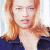 A pixelated image of a person with long light brown hair wearing dark clothing, next to green text on a dark background.