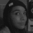 Black-and-white photo of a person wearing a dark beanie with a small white patch, showing multiple facial expressions and head positions across six