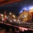 Pixelated static image showing a blurred interior with warm lighting and indistinct shapes suggesting a theater or performance space.