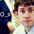 Pixelated image of a dark blue cartoon fish with large white eyes and a light-colored mouth next to a person in a white shirt.