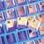 A static pixelated image with a grid of overlapping, blurred, and distorted shapes in blue, purple, and beige tones, lacking distinct subjects or text.