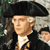 Static pixelated image of a historical figure wearing a black tricorn hat and dark coat with white cravat, set against a muted background.