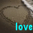A heart drawn in sand with a metal object, overlaid with cyan text reading 'love' in a