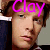 A pixelated image of a person with brown hair and light skin, featuring the word "Clay" in bright pink text on the left side and white text on the right side.
