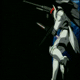 A white mecha with red head accents and blue details holds a long sword, shown in multiple poses against black backgrounds with one frame featuring Earth.