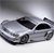 Pixelated grayscale image of a silver sedan with black roof and windows, viewed from a low angle against a gradient background.