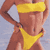 Pixelated static image of a person in yellow bikini top and brown bottoms against light blue background, viewed from side with arm raised holding object.