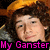 A split-screen image with a person on the left and a grayscale face on the right, both overlaid with pink text reading "My Love" and "My Ganster."