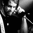 Black-and-white pixelated image of a person with text overlays reading 'David Cook' and 'Is the BEST!!', showing partial motion in hand gestures.