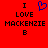 Red background with black text reading "I LOVE MACKENZIE B" and a blue pixelated heart symbol above the word LOVE on the left side.