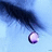 A pixelated image with a blue background showing a dark object dripping a purple droplet, accompanied by green text on a brown backdrop.