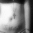 A grayscale animated icon shows a person's torso with a small cross tattoo on the abdomen, visible through a partially unbuttoned shirt, with subtle motion in the background elements.