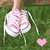 A static image showing a pair of pink and white sneakers on grass with a small pink heart, alongside three larger hearts in pink, green, and cyan.