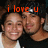 Two people in close proximity with orange text 'i love u' above them on a dark background.