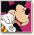 A pixelated cartoon image of Minnie Mouse in a close-up pose with her hand near her face, next to green text reading "Original Icons .com" on a dark background.