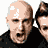 A 3x2 contact sheet of six pixelated frames showing a man with varying hairstyles and expressions, some wearing black shirts or caps, with "CoolBuddy.com" text visible in one frame.