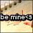 Pixelated image with text "be mine" overlaid on a background of scattered brown objects and orange shapes.