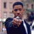 A pixelated image shows a person holding a silver object toward the viewer, with green text reading "Original Icons .com" on a dark background.