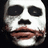 Pixelated face with white skin, black eye sockets, and brown lips against a dark background.