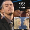 Static image of a person in a dark suit with a light-colored shirt and dark tie, positioned above a smaller inset image of two people kissing.