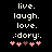 Pixelated text reads 'live. laugh. love.' followed by ':dory:' with five pink and brown heart symbols below on black background.