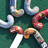 candy cane-shaped objects on a green background with some white and gray areas