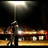 Animated scene of a figure walking under streetlights with blurred background lights, showing motion across frames.