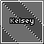 Pixelated grayscale icon with diagonal black-and-white dotted lines forming a cross, featuring the name 'Kelsey' in bold white text on a black rectangular background.