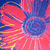 A pixelated flower with red petals, yellow stripes, and a blue center, displayed in a