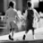 Black-and-white pixelated image of two figures walking side-by-side with text reading "we've kept our promise<3" in four quadrants.