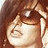 Pixelated close-up of a person with brown hair and sunglasses, accompanied by pink text reading BE GLAMOUROUS !!! on white background.