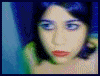 Animated sequence of a person with dark hair and blue eyeshadow in various poses and lighting conditions, including close-ups and full-body views.
