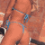 Static 50x50 pixel icon with orange-brown background and blue-gray abstract shapes resembling limbs or motion trails.