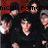 Pixelated image showing multiple figures with light skin tones against a dark background, partially obscured by red and black text.
