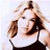 Pixelated image of a person with light brown hair wearing dark sunglasses and a white sleeveless top against a pale background.