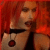 Pixelated image of a person with red hair holding a black handgun against their chest, set against a solid red background.