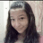 Static pixelated image of a person with long dark hair wearing a black top against a light background.