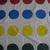 A grid of circular icons in four rows: red, blue, yellow, and dark green on a light gray background with subtle diagonal lines.