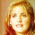 Pixelated close-up of a person with light brown hair holding a phone to their ear, set against warm-toned background.
