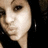Pixelated close-up of a person's face with light skin tone, dark eye visible on left side, and black background.