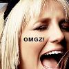 A close-up of a person with light blonde hair, mouth open in a shout, and black text overlaid on the cheek.