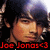 Pixelated static image of a person with dark hair and light skin, red text reading 'Joe Jonas<3' at the bottom.