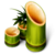 Green bamboo stalks with cut ends showing orange-brown interiors, one tall and two shorter pieces arranged against a gray background.