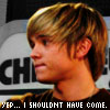 A close-up profile view of a person with light brown hair and a dark shirt, with text at the bottom reading "YEP... I SHOULDN'T HAVE COME.".