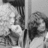 Black-and-white pixelated image of two figures in a split composition with one figure on the left and one on the right, both partially obscured by pixelation.