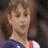 A pixelated image of a person with brown hair wearing a blue and red outfit, next to an animated sequence showing a figure on a balance beam.