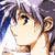 Pixelated close-up of a character with light skin, brown hair, and a white top with orange accents, set against a blurred background with blue and purple tones.